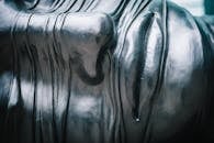 Close-up view of a textured metallic sculpture emphasizing patterns and reflections.